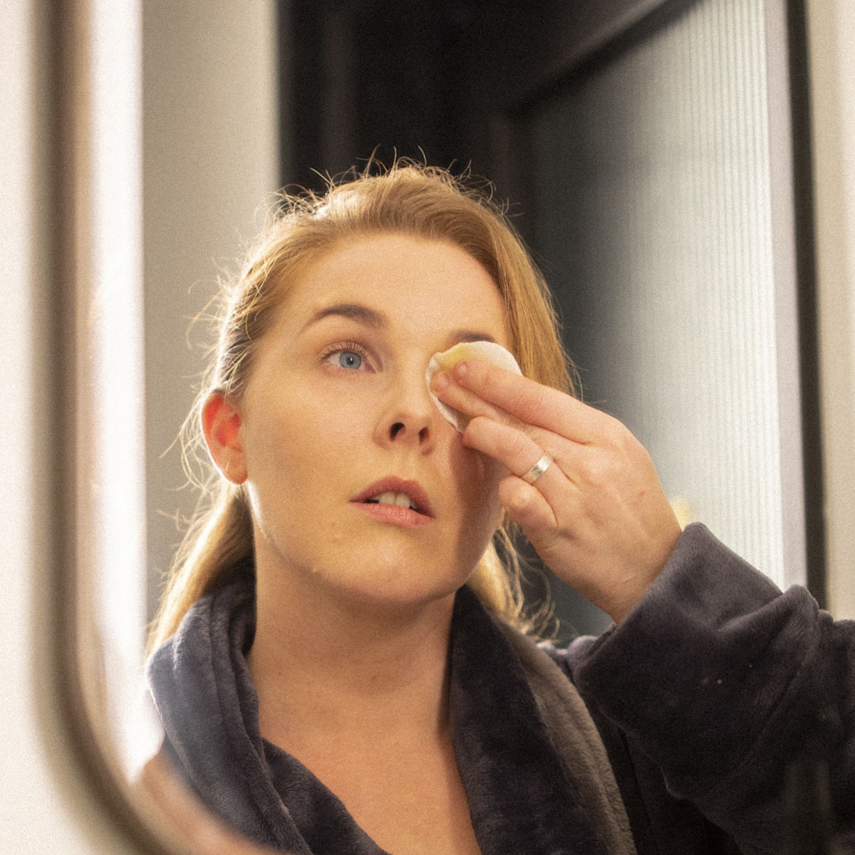 Woman using eye makeup remover