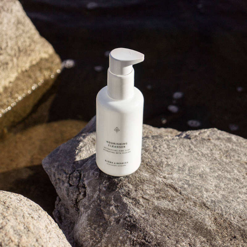 Björk & Berries Nourishing Cleanser. Bottle on a cliff.