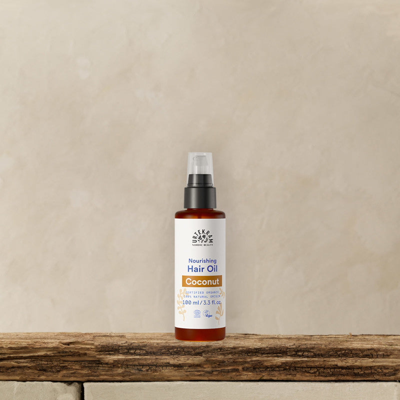 URTEKRAM Nourishing Hair Oil, Coconut. Bottle on a shelf.