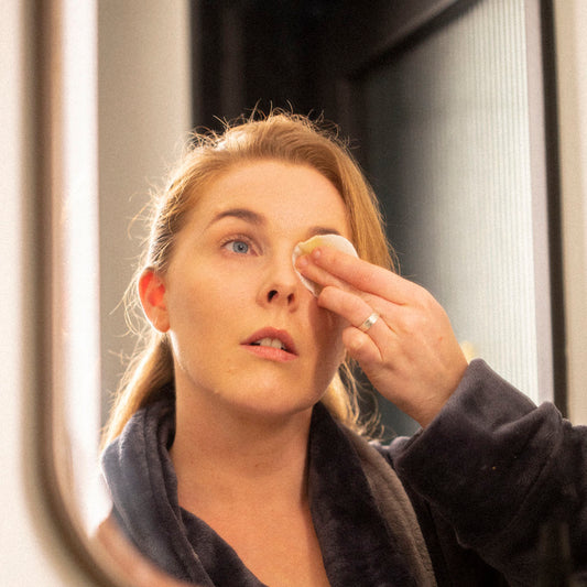 Woman using eye makeup remover