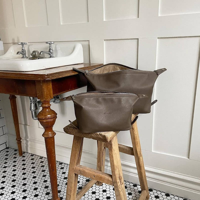 Bon Voy, 2 beauty bags on stool in bathroom