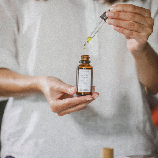 Woman holding a bottle of face oil