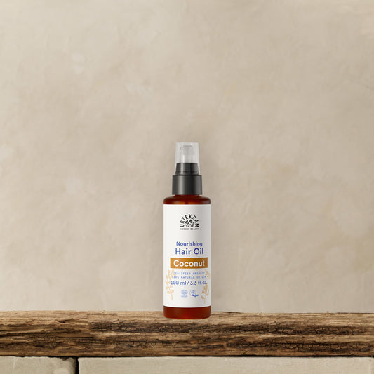 URTEKRAM Nourishing Hair Oil, Coconut. Bottle on a shelf.