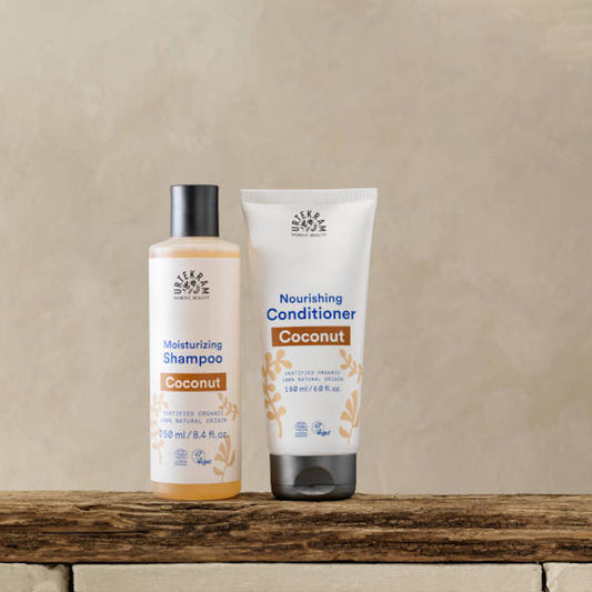 URTEKRAM Moisturizing Shampoo and nourishing Conditioner, Coconut. 2 Products on a bench. 